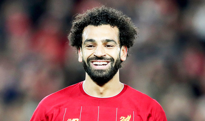 Liverpool's Mohamed Salah smiles after scoring his side's third goal during the Champions League group E soccer match between Liverpool and Red Bull Salzburg at Anfield stadium in Liverpool, England, Wednesday, Oct. 2, 2019. (AP)