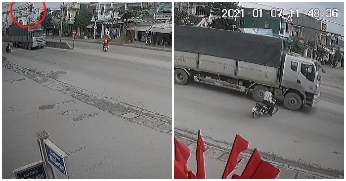 Người đàn ông drift xe máy tránh ôtô tải vượt đèn đỏ.