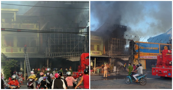 Ngọn lửa thiêu rụi cửa hàng điện máy và gây ảnh hưởng đến một trung tâm điện máy bên cạnh cùng các nhà dân lân cận (ảnh chụp màn hình trên báo Dân Trí/Tuổi Trẻ).