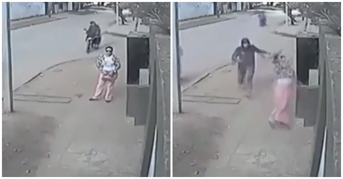 Cô gái ném túi xách qua tường vào nhà khi thấy cướp (ảnh cắt từ clip).