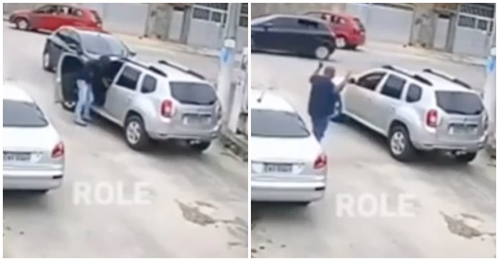 Sau khi đuổi tài xế ra ngoài, tên cướp nhảy vào ghế lái nhưng lại không biết điều khiển chiếc xe như thế nào (ảnh cắt từ clip).