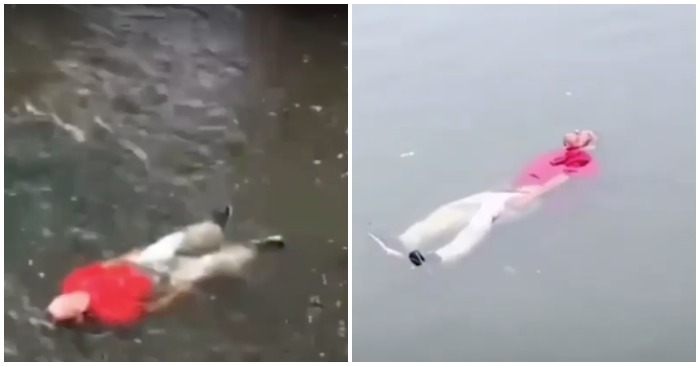 Người đàn ông tự thả trôi trên sông (ảnh chụp màn hình video).